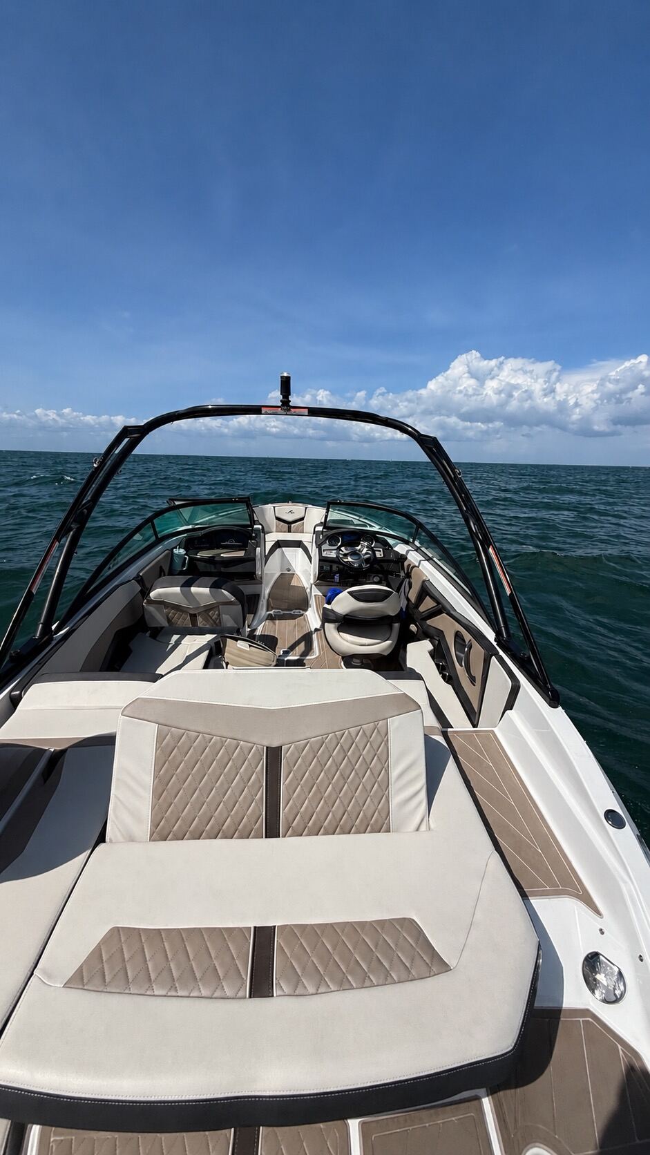 The open bow of the Baycation boat anchored over clear shallow water on Tampa Bay